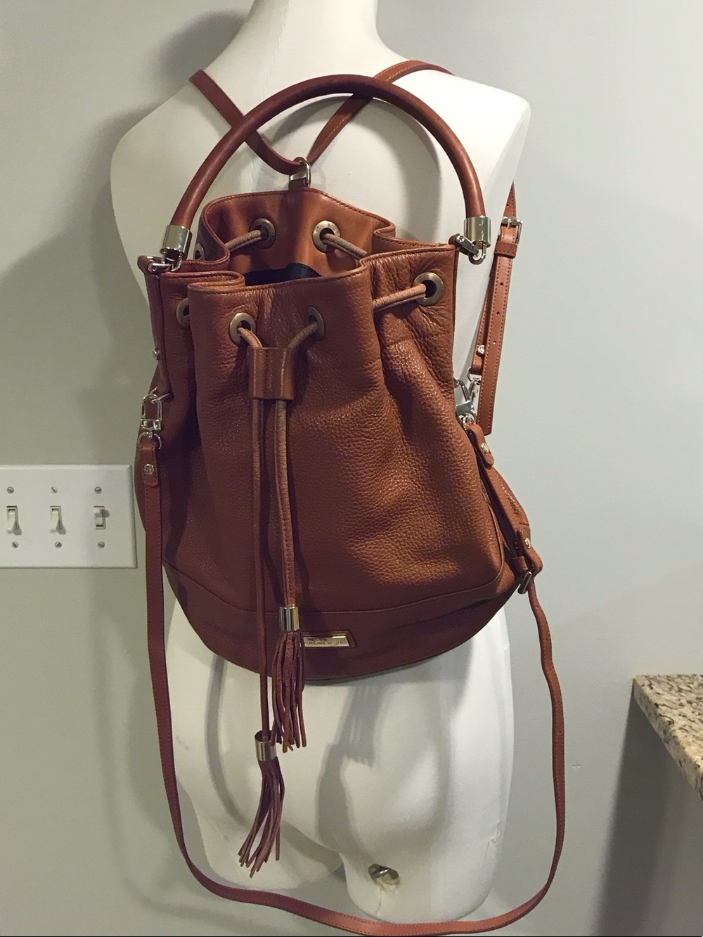 Tassel Drawstring Bucket Backpack in Cognac Backpaback bag